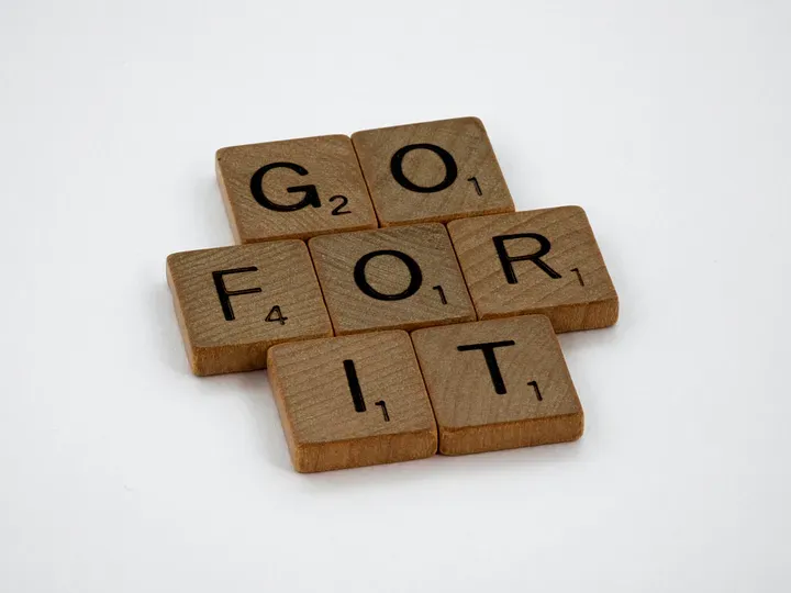 Scrabble tiles spelling "Go For It"